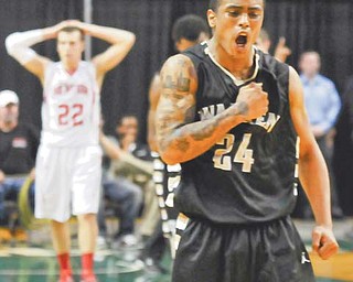 Warren Harding’s Rasaun Smith thumps his chest as he walks off the court after the Raiders defeated Mentor in the Division I regional final Wednesday at Cleveland State University. With 19 seconds left to play, Smith got Mentor’s Justin Fritts, background, to lose control of the ball, which he then snatched away and converted for a bucket to give the Raiders the lead and 57-54 win.