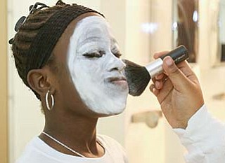 Cierra Gordon, 10, of Austintown holds her breath as white powder is applied to her face to look the part of a mime.