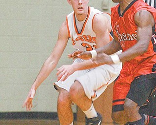Ron Rogers of Springfield tries to evade Chanel’s Brionne Duke (2) during the Division III regional semifinal
Wednesday at Canton Memorial Fieldhouse. The Firebirds were too much for the Tigers, who lost 55-37.