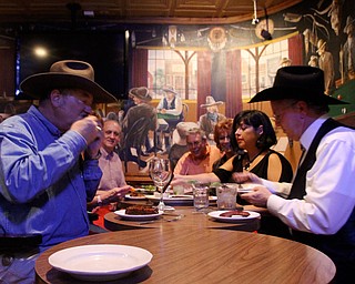 Jack Edmondson, left and Ken Morgan, right, of Fort Worth, along with a handful of friends, enjoyed dinner Wednesday night at Cattlemen's Steakhouse in the city's Historic Stockyards District. The group gets together weekly to discuss the area's hot topics, which often consist of the Barnett Shale, a major natural-gas geologic formation. Wednesday's topic focused on natural-gas vehicles.