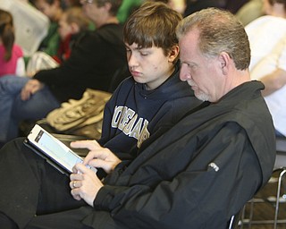 ROBERT  K.  YOSAY  | THE VINDICATOR --..I SPELL --  Greg and Andrew Rossi  work their I Pad - as  THE BEE went on Andrew last appeared in 2010  ( his fourth time)The 79th  Regional Spelling Bee sponsored by the Vindicator was held at YSU Kilcawley Center with 65 spellers vieing for the coveted trophy and trip to Washington for the National Spelling Bee s--30-..(AP Photo/The Vindicator, Robert K. Yosay)