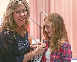 ROBERT  K.  YOSAY  | THE VINDICATOR --..Mom and daughter  Miranda Keck  from Jackson Milton  Elementary  shares a laugh with her mom Kim as Ki puts on the sash before The 79th  Regional Spelling Bee sponsored by the Vindicator was held at YSU Kilcawley Center with 65 spellers vieing for the coveted trophy and trip to Washington for the National Spelling Bee s--30-..(AP Photo/The Vindicator, Robert K. Yosay)