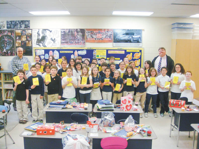 As one of its literacy projects, the Struthers Rotary Club distributes more than 300 dictionaries to all fourth-grade students in Struthers, Campbell and Lowellville. The Dictionary Project was created to provide a dictionary to each student to help with schoolwork. Rotarians Mike Evanson, far right, and Tom Baringer stand with the entire fourth-grade classes of teachers Dave Olson and Michele Perry in Lowellville with their new dictionaries.