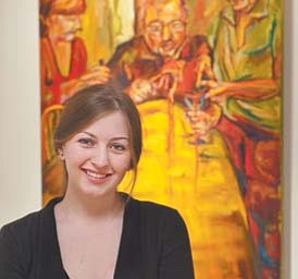 Nikki Mehle, a Canfield High School graduate and a student at the Cleveland Institute of Art, has won a
prestigious award for her painting “Dinner Time,” which is shown here in the background.