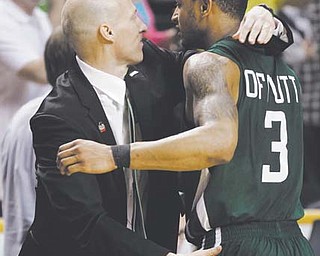 Ohio head coach John Groce embraces guard Walter Offutt (3) after the Bobcats’ 65-60 win over Michigan in Round 2 of the men’s NCAA basketball tournament in Nashville, Tenn. The Bobcats, who have become the tournament’s latest mid-major darlings, knocked off South Florida in Round 3 to reach the Sweet 16 for the first time since 1964. They face North Carolina on Friday.