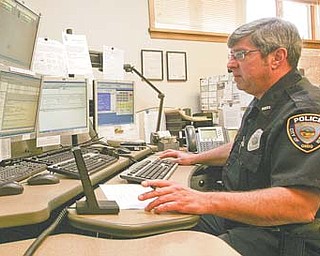 Lonny Fitzsimmons, a 911 dispatcher for Hubbard, keeps an eye on monitors connected to security cameras throughout the city. For the 2013 budget, the city is looking into options for cutting costs for 911 dispatching.
