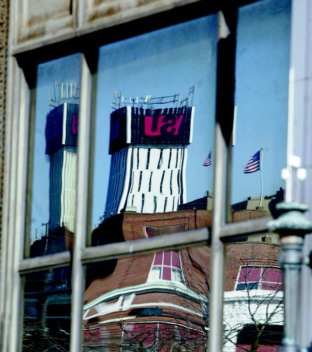 The YSU logo is reflected in Stambaugh Building window.