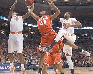 Ohio State guard William Buford (44) tries to grab a rebound between Syracuse forwards C.J. Fair (5) and James
Southerland during the second half of the East Regional final game in the NCAA men’s college basketball
tournament Saturday in Boston.