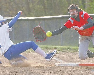 Poland’s Amanda Kabetso (7) slides safely back to first base on a pick-off attempt by Girard during their game Tuesday in Girard. Indians first baseman Bryanna Jay reaches for the ball on the play.
