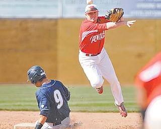 Youngstown State’s Padriac Williams throws to first base for the double play after stepping on second base to
force out Akron’s Dan Burant during Tuesday’s game at Eastwood Field.