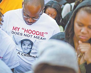 Andre Parker of Atlanta wears a T-shirt in memory of Trayvon Martin, the unarmed 17-year-old who was
killed by a Florida neighborhood-watch captain while returning from a convenience store, during a rally
outside the Georgia Capitol in Atlanta. The Martin case quickly is becoming an Internet-fueled brand.