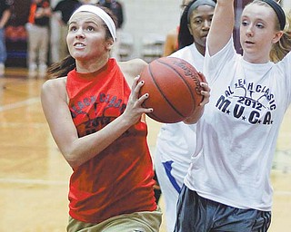 Lowellville’s Ashley Moore, playing for the Red Team, drives to the hoop after getting past the White Team’s Rachel Ellis of Newton Falls during the Al Beach Classic on Wednesday at Boardman High School. Red defeated White, 54-49, in overtime, with Moore named the game’s Most Valuable Player.