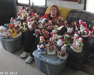 Shelly Toth shows off her collection of animated Christmas statues.