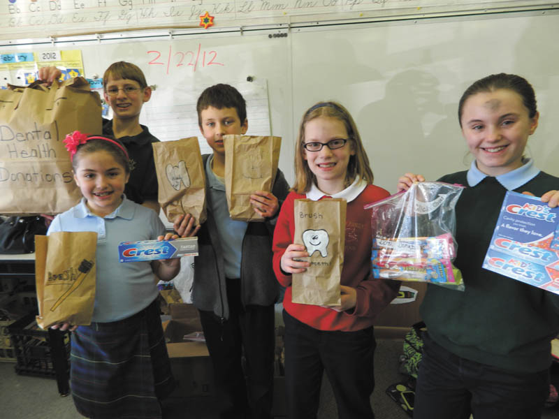 Students at Holy Family School in Poland display some of the dental supplies they donated to the Rescue Mission on Ash Wednesday. Toothbrushes, toothpaste, dental floss and many other supplies were sent. From left to right are Audrey Kali, grade three; Mario Abbattista, grade eight; Stephen Babik, grade five; Maren Abbattista, grade four; and Katherine Kali, grade five. 