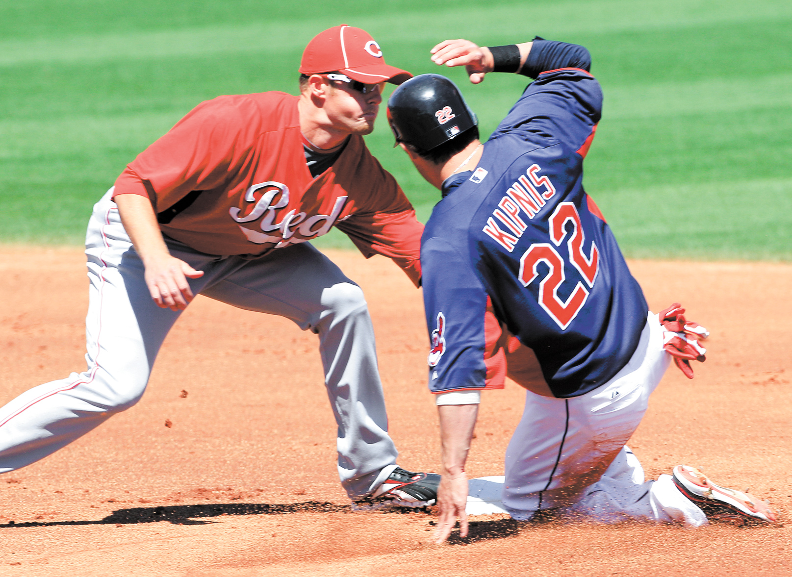 Cincinnati Reds shortstop Zack Cozart tags out Cleveland Indians’ Jason Kipnis (22) on an attempted steal of second in the first inning of Monday’s spring training game in Goodyear, Ariz. Kipnis is one of the Indians’ young players being counted on 2012.