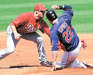 Cincinnati Reds shortstop Zack Cozart tags out Cleveland Indians’ Jason Kipnis (22) on an attempted steal of second in the first inning of Monday’s spring training game in Goodyear, Ariz. Kipnis is one of the Indians’ young players being counted on 2012.