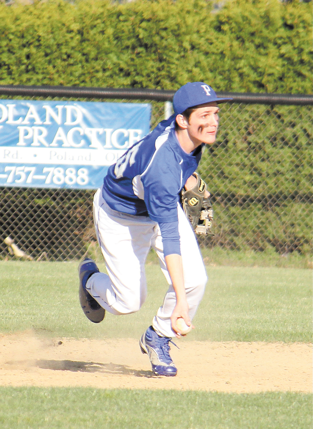 Poland shortstop Nicholas Maillis (25) scoops the ball and prepares to toss it to second base to force an
out in the third inning of Monday’s game against Austintown Fitch. The Bulldogs won the AAC game 13-11.