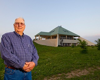 Lewayne Peterson stands in front of the pyramid home he built in Justin, Texas near Fort Worth with wealth he gained from gas drilling on his land.