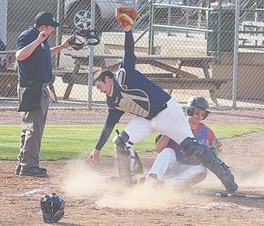 Parker Clegg slides home to score for Western Reserve as Lowellville’s Nick Micco loses the ball.