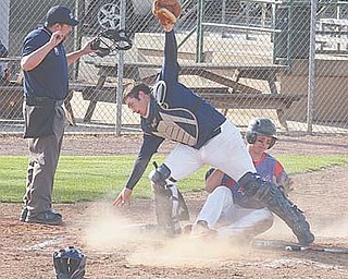 Parker Clegg slides home to score for Western Reserve as Lowellville’s Nick Micco loses the ball.