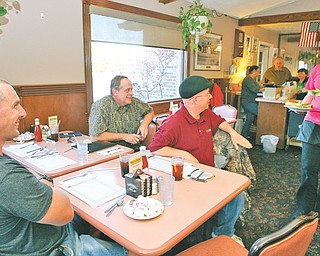 The Burger Boys turn to their waitress, Megan Logan, as she arrives with their burger choices from Yankee Kitchen in Vienna.