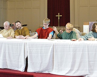 Members of Central Christian Church in Warren practice being “frozen” in place to echo the Leonardo da Vinci painting of the Last Supper. Eleven of the 12 apostles participated in a recent rehearsal for the “Living Last Supper,” which the church will present at 7 tonight for its observance of Maundy Thursday.