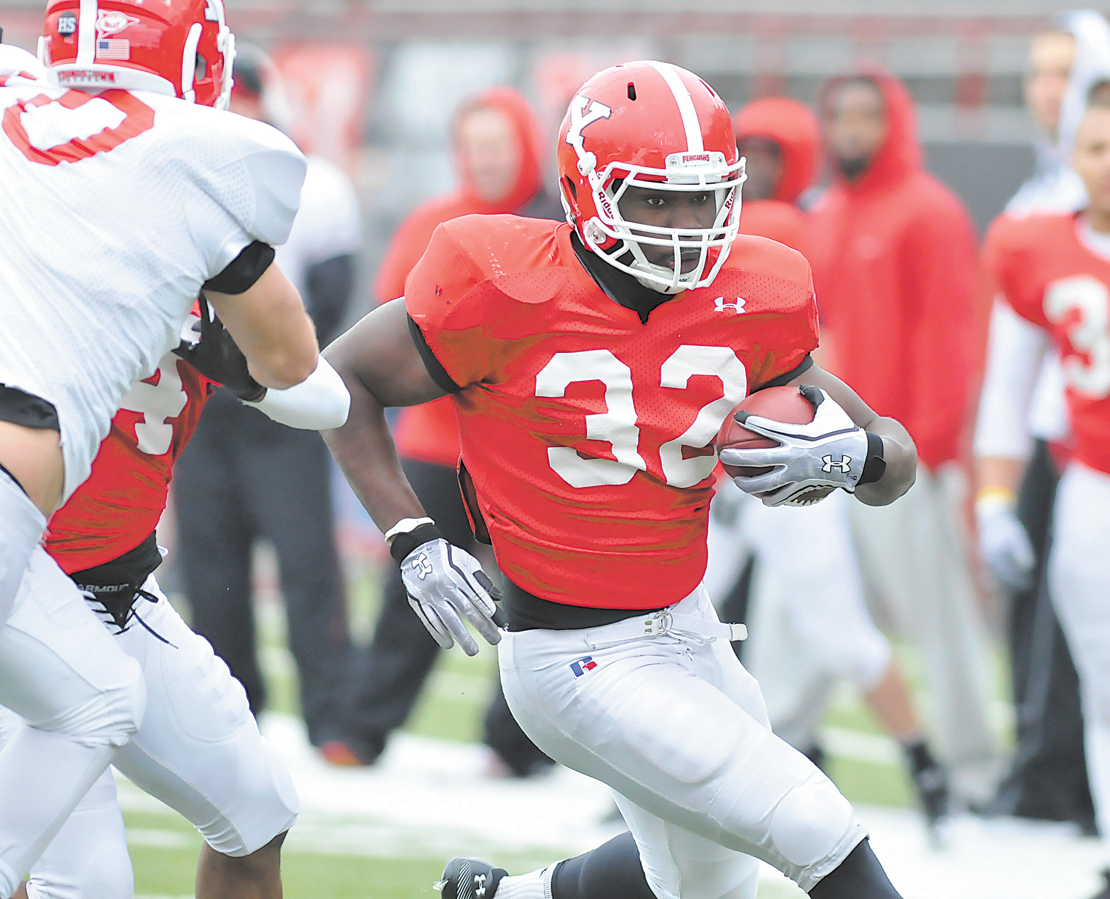 Youngstown State running back Jordan Thompson (32) evades a defender during the Penguins’ first spring scrimmage March 31 at Stambaugh Stadium. While the offense has dominated for much of the first two weeks of spring, the defense took a step forward on Wednesday, doing enough to please head coach Eric Wolford.