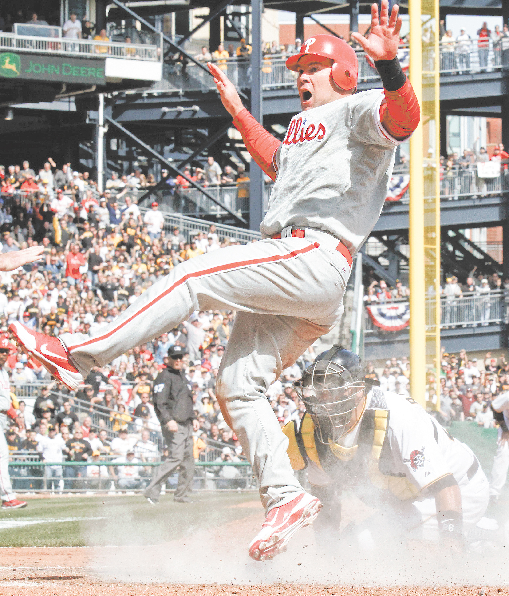 Philadelphia Phillies’ baserunner Ty Wigginton scores ahead of the tag by Pittsburgh Pirates catcher Rod Barajas in the seventh inning of the Pirates’ season opener Thursday at PNC Park in Pittsburgh Wigginton
tagged up and scored from third base on a sacrifice fly by teammate Carlos Ruiz to Pirates right fielder
Jose Tabata. The Phillies won 1-0. The two teams square off Saturday in Pittsburgh.