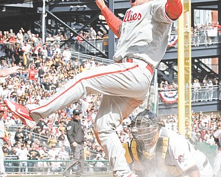 Philadelphia Phillies’ baserunner Ty Wigginton scores ahead of the tag by Pittsburgh Pirates catcher Rod Barajas in the seventh inning of the Pirates’ season opener Thursday at PNC Park in Pittsburgh Wigginton
tagged up and scored from third base on a sacrifice fly by teammate Carlos Ruiz to Pirates right fielder
Jose Tabata. The Phillies won 1-0. The two teams square off Saturday in Pittsburgh.