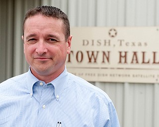 Calvin Tillman, former mayor of Dish, Texas, who stands in front of the town hall.