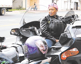 Sondra “Honey” Jones of Youngstown sits on her motorcycle at Jokers Wrath on Market Street in Youngstown, waiting for the rest of the “Dangerous Curvez” motorcycle club. The group participated Sunday in a motorcycle run to raise money for Trayvon Martin’s family.