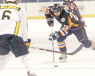 Phantoms forward Alexander Dahl shoots past Green Bay’s Andrew Welinski during a recent game at the Covelli Centre.