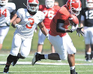 Youngstown State’s Kevin Watts, right, makes a catch after bobbling the ball during a recent scrimmage.
Linebacker Teven Williams (3) pursues.