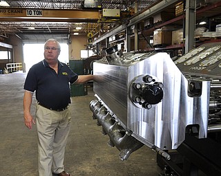 David Capps, operations manager at FTS, stands in front of a pump manufactured by the Fort Worth based company.