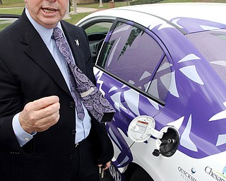 Ken Morgan, director of the Energy Institute at TCU, shows off his natural gas-powered Honda Civic as he explains the benefits.