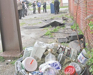 Beverage bottles fill a garbage can outside a condemned former bakery on Youngstown’s South Side as U.S. Sen. Sherrod Brown, D-Ohio, and local leaders conduct a Tuesday news conference to promote the Project Rebuild Act now being considered by Congress. The Project Rebuild Act would replace the Neighborhood Stabilization Plan and would provide about $15 billion in assistance and grants to communities to renovate or tear down dilapidated structures.