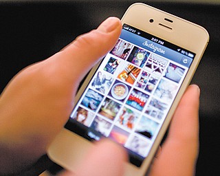 Instagram is demonstrated on an iPhone in New York. Facebook is spending $1 billion to buy the photo-
sharing company Instagram in the social network’s largest acquisition ever. Instagram lets people
apply filters to photos they snap with their mobile devices and share them with friends and strangers.