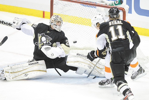 The Pittsburgh Penguins’ Jordan Staal (11) watches as the Philadelphia Flyers’ Jakub Voracek, back right, scores the game-winning goal past Penguins’ goalie Marc-Andre Fleury (29) during the overtime period in Game 1 of the Eastern Conference quarterfi nals Wednesday at Consol Energy Center in Pittsburgh. The Flyers won 4-3 to grab a one-game lead in the series.