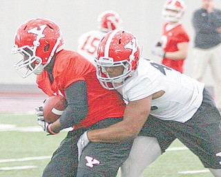 Youngstown State sophomore linebacker Teven Williams (45) tackles junior wideout Kevin Watts during
Wednesday’s practice at the WATTS. Williams is one of the top returnees on a young Penguin defense.