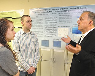 Omega Laboratories CEO John Vitullo, right, a 1975 Youngstown State University graduate, speaks with YSU students Danielle Fontaine and Joshua Pastor. Vitullo returned to campus Friday to speak to the biology department about drugs in the United States. Omega, of Mogadore, Ohio, is an organization that creates drug-testing products.