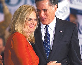 Republican presidential candidate Mitt Romney and his wife, Ann, hug during a victory rally in Schaumburg, Ill.