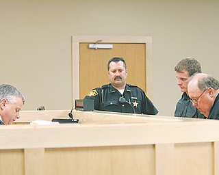 Judge Joseph M. Houser, left, presides over the opening session of the new Boardman Court, 8110 Market St., on Thursday afternoon. Appearing before him on operating a vehicle while intoxicated and drug possession charges is Matthew Tomko, 22, of Canfield. Tomko’s lawyer, far right, is Stephen Garea.