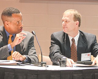 Jay Williams, left, former Youngstown mayor and current executive director of the U.S. Office of Recovery for Auto Communities and Workers, makes a point at Thursday’s manufacturing summit in Youngstown. Jim Herrholtz, assistant superintendent for the division of learning for the Ohio Department of Education, listens.