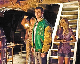 Fran Kranz, left, Chris Hemsworth and Anna Hutchison star in “The Cabin in the Woods.”