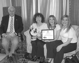 The Rotary Club of Youngstown is gearing up for its 13th annual reverse raffle and silent auction fundraiser April 27 at The Embassy in Youngstown. Admiring some of the gifts donated to the auction are, from left, Bill Petro, committee member; Linda Kostka, committee member; and Elayne M.S. Bozick and Debbie Esbenshade, raffle co-chairwomen.