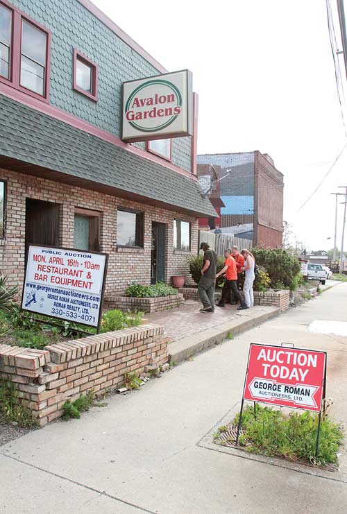 Those entering the Avalon Gardens auction stand outside as the sale progresses inside the former tavern and restaurant on Belmont Avenue. The contents of the North Side landmark were sold Monday.