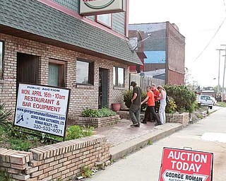 Those entering the Avalon Gardens auction stand outside as the sale progresses inside the former tavern and restaurant on Belmont Avenue. The contents of the North Side landmark were sold Monday.