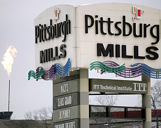 The flare from the gas burnoff from a Marcellus Shale well is seen over the Pittsburgh Mills mall in Tarentum,
Pa. The flaring is a controlled burn to release pressure and test the volume of gas inside a well, according
to drilling company Range Resources.