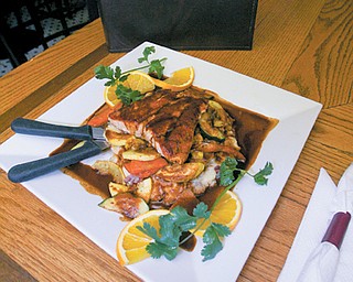 The Plaza Azteca restaurant in Niles features upscale Mexican cuisine such as this Salmon Pasilla dish, which includes a pan roasted Salmon filet, grilled vegetables, garlic mashed potatoes and a honey Pasilla sauce.