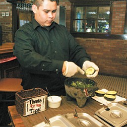 Employee Trino Ortega makes fresh guacamole. Customers can choose how much of which ingredients to make the guacamole suit their preferences in flavor and spiciness.